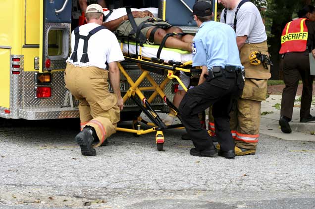 A man being lifted into an ambulance.